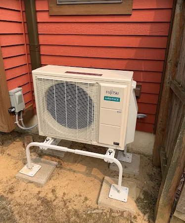 Fujitsu heat pump outdoor unit installed outside a home