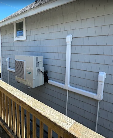 Ductless mini-split line set and condenser installed on a coastal home