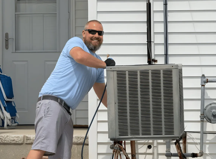 Conlow technician servicing an outdoor air conditioning condenser